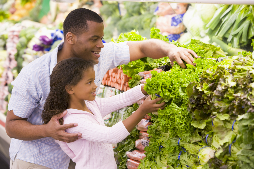 Clients man and child buying vegetable